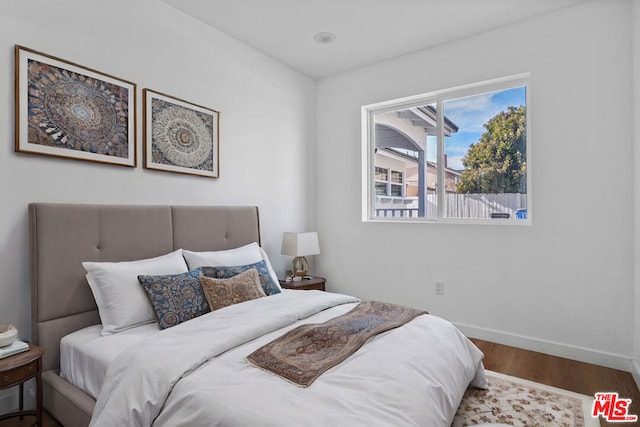 bedroom with wood-type flooring