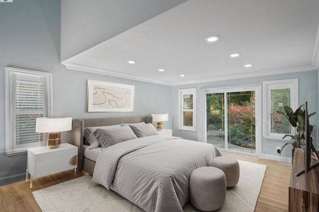 bedroom with light hardwood / wood-style floors and crown molding