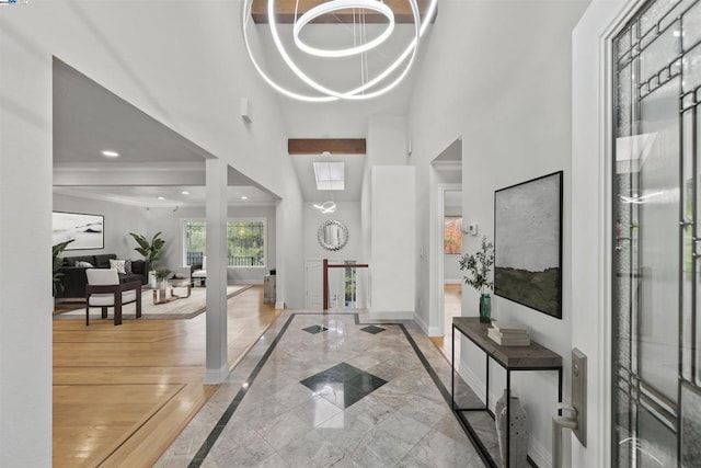 foyer with a high ceiling and an inviting chandelier