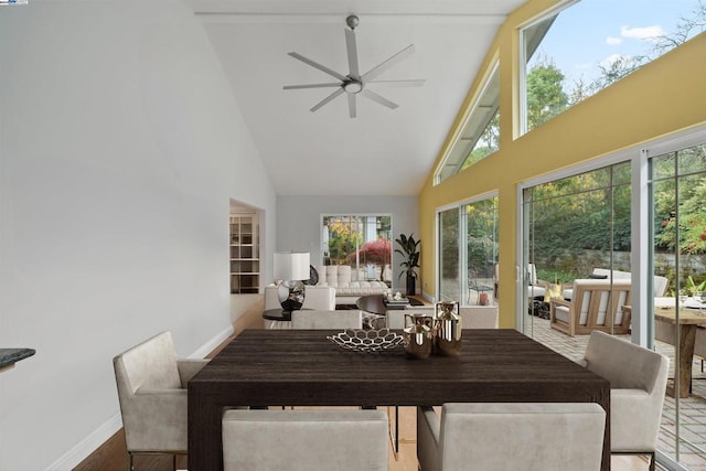 sunroom / solarium with lofted ceiling, a healthy amount of sunlight, and ceiling fan