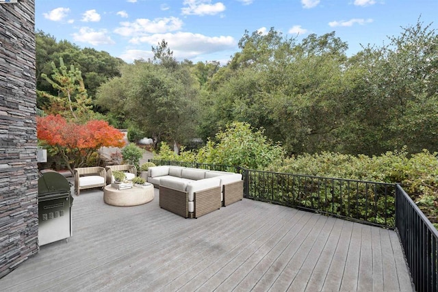 deck featuring an outdoor living space and area for grilling