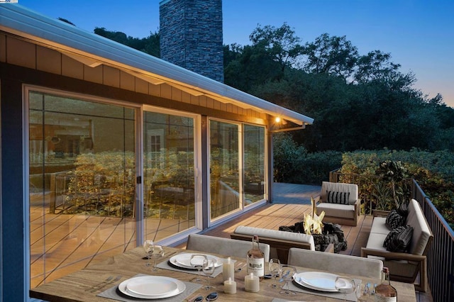 deck at dusk with a fire pit