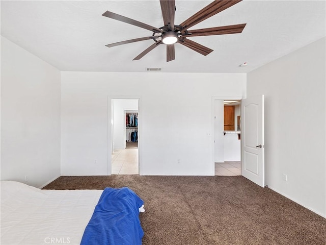 unfurnished bedroom featuring light carpet and ceiling fan