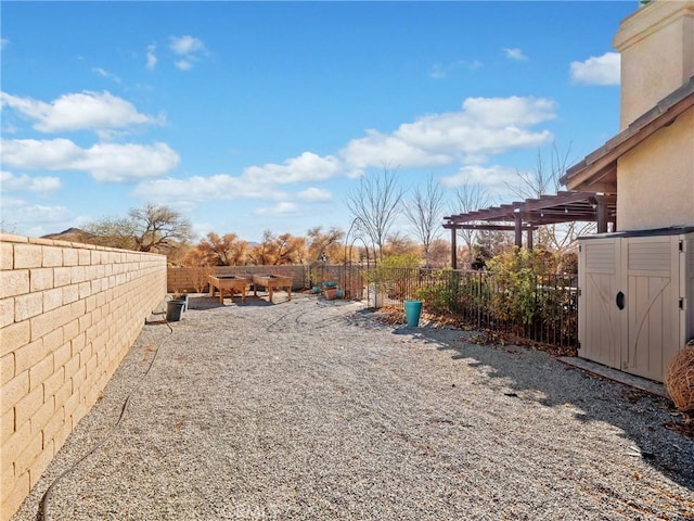 view of yard with a pergola and a storage unit