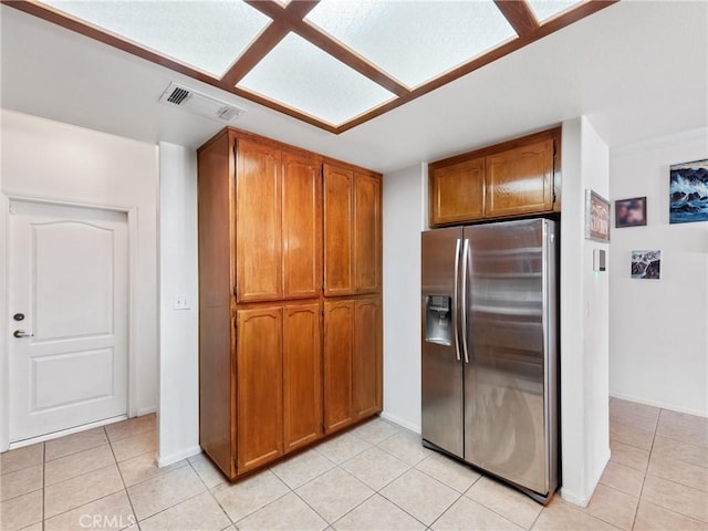 kitchen featuring stainless steel fridge with ice dispenser and light tile patterned floors