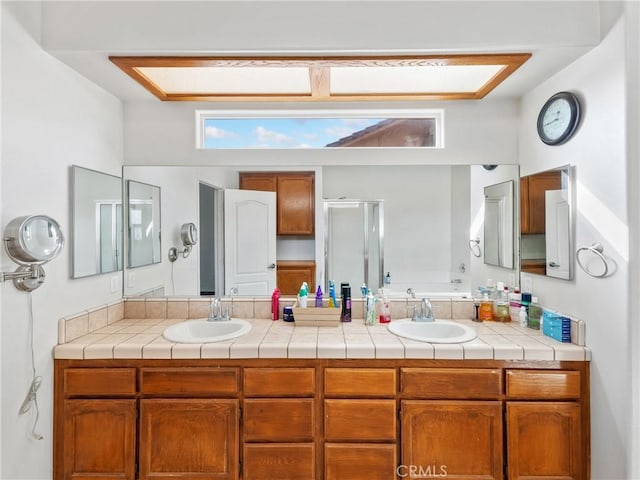 bathroom with vanity and a shower with door