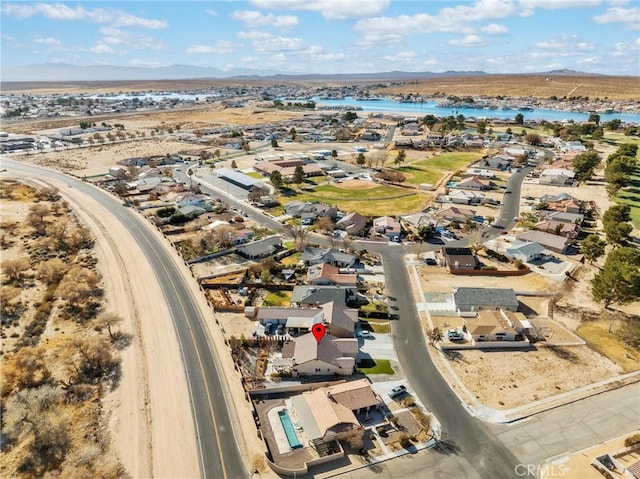 drone / aerial view with a water and mountain view