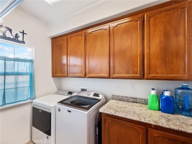 laundry area with cabinets and independent washer and dryer