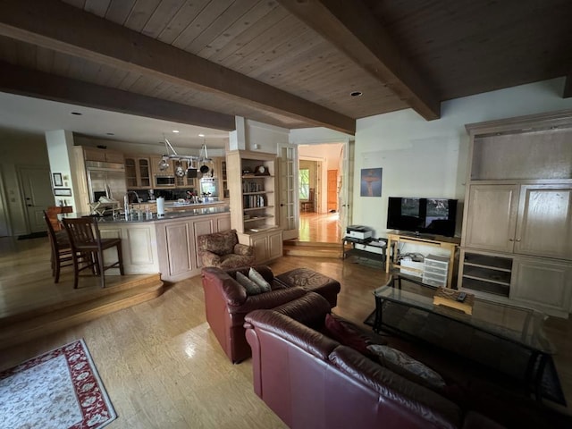 living room with beam ceiling, wood ceiling, and light wood-type flooring