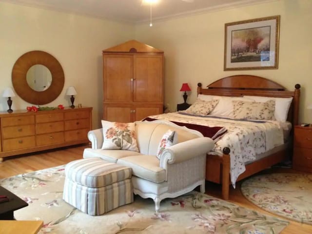 bedroom featuring crown molding and light hardwood / wood-style flooring