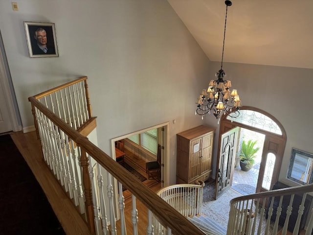 foyer entrance featuring high vaulted ceiling and a notable chandelier