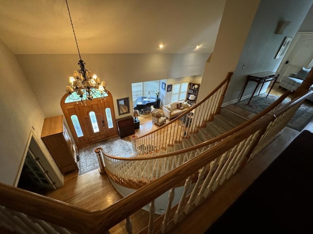 interior space with high vaulted ceiling and a notable chandelier