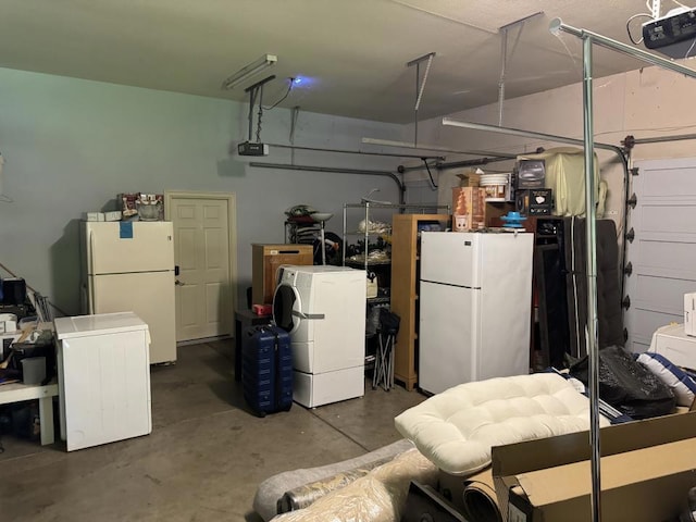 garage featuring white refrigerator and a garage door opener