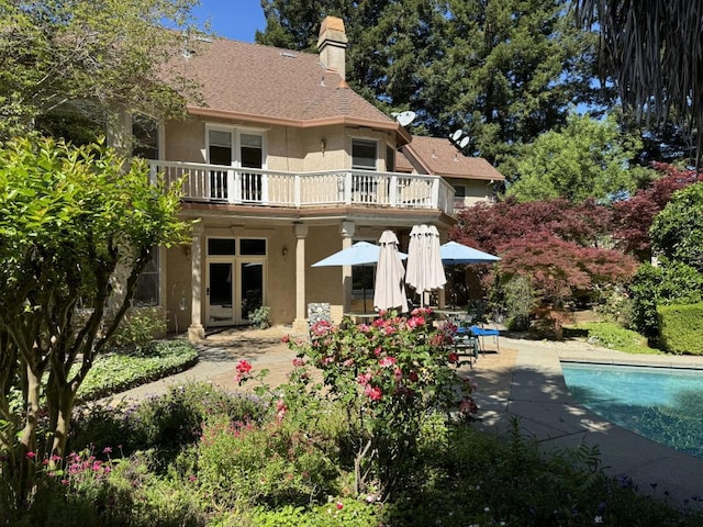 back of house featuring a patio area and a balcony