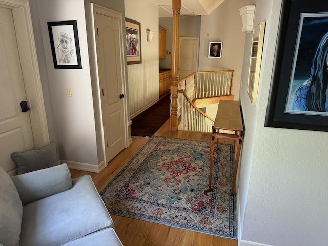 hallway featuring hardwood / wood-style floors and lofted ceiling