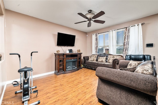 living room featuring ceiling fan and light wood-type flooring