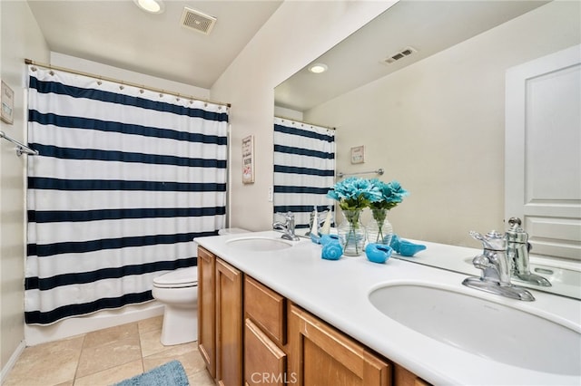 bathroom with walk in shower, tile patterned flooring, vanity, and toilet