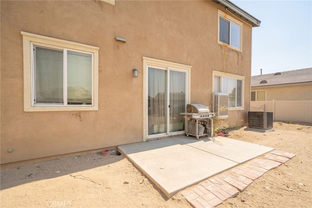 rear view of property with a patio and central AC