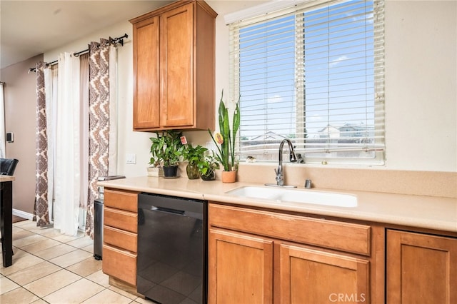 kitchen with dishwasher, light tile patterned floors, and sink