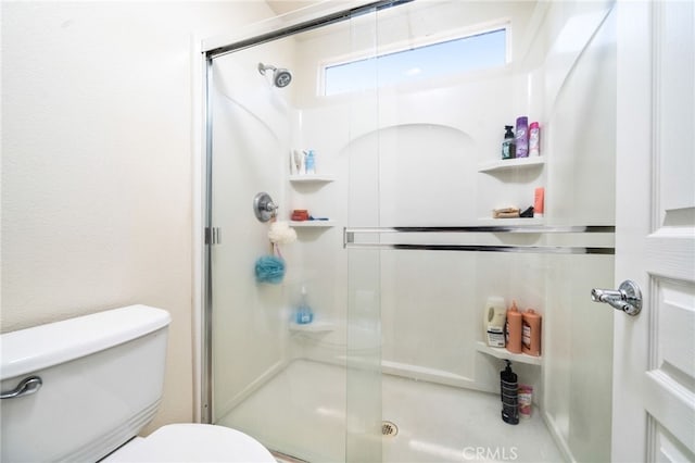 bathroom with toilet and walk in shower