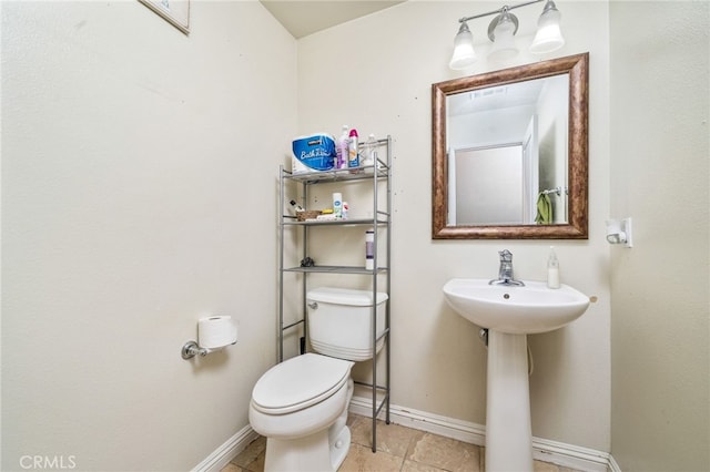 bathroom with tile patterned floors, toilet, and sink