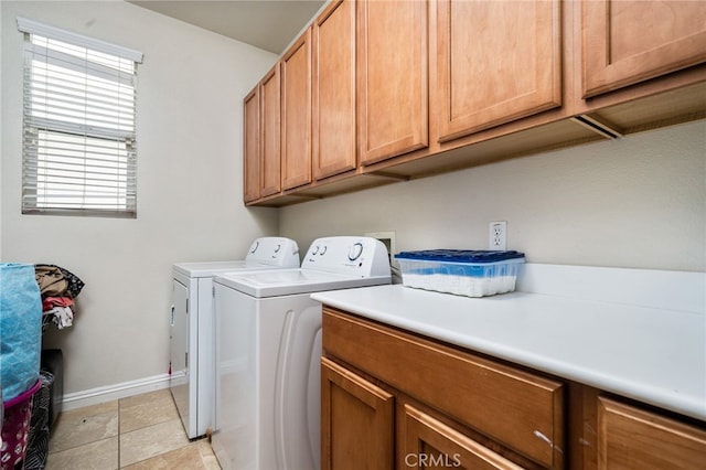 laundry area with washer and clothes dryer and cabinets