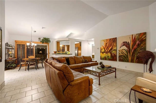 living room featuring vaulted ceiling, an inviting chandelier, and light tile patterned flooring