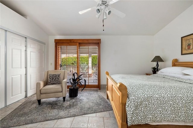 bedroom with ceiling fan, vaulted ceiling, a closet, and light tile patterned flooring