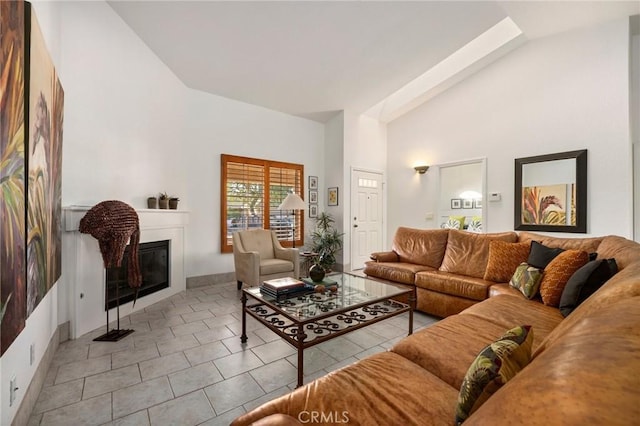 living room featuring high vaulted ceiling and light tile patterned floors