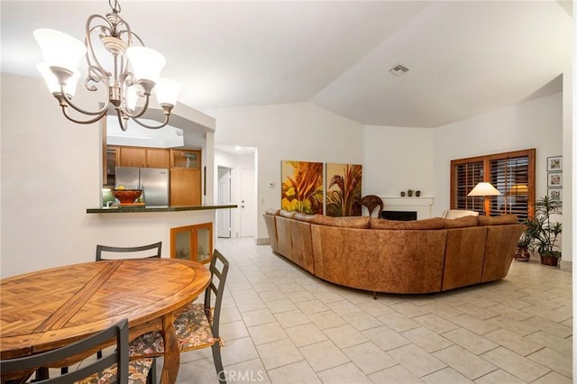 tiled living room with vaulted ceiling and an inviting chandelier