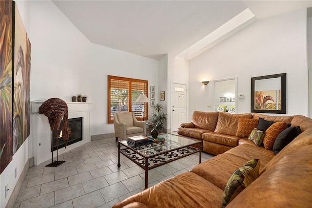 tiled living room featuring high vaulted ceiling