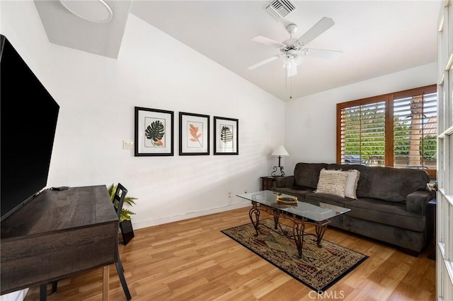 living room featuring light hardwood / wood-style floors, lofted ceiling, and ceiling fan