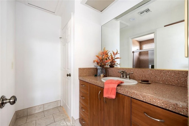 bathroom featuring tile patterned flooring and vanity