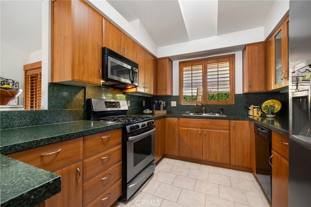 kitchen with stainless steel appliances, decorative backsplash, light tile patterned flooring, lofted ceiling, and sink