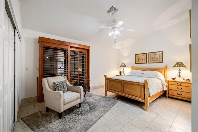 tiled bedroom with ceiling fan, a closet, and vaulted ceiling