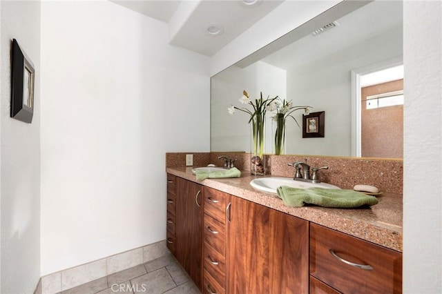 bathroom featuring tile patterned flooring and vanity