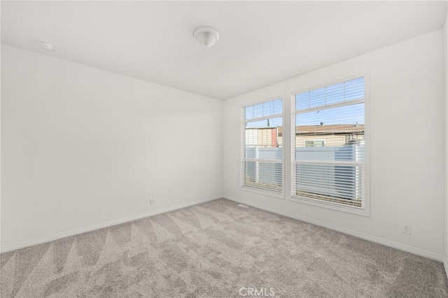 spare room with light colored carpet