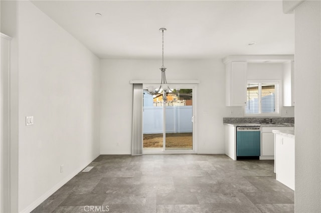 unfurnished dining area with a notable chandelier