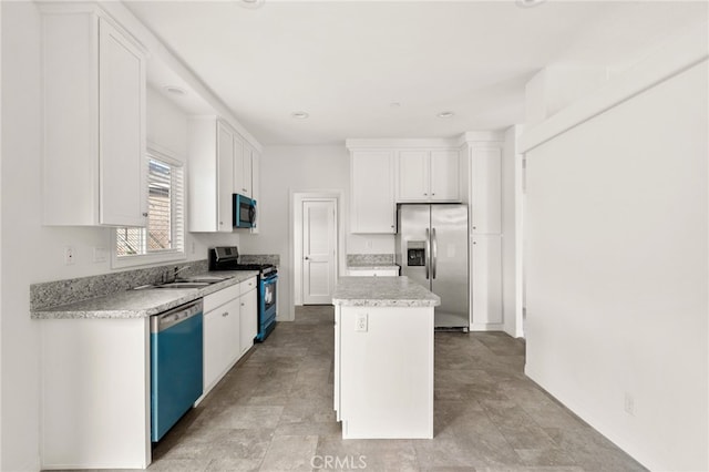 kitchen featuring white cabinets, a center island, sink, and appliances with stainless steel finishes