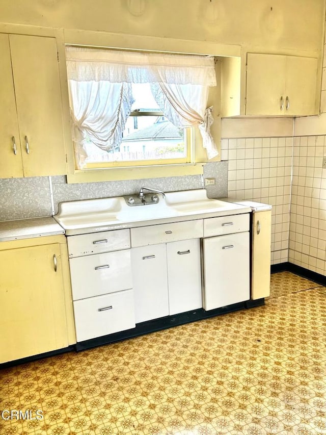 kitchen with white cabinetry and backsplash