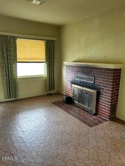 unfurnished living room featuring a fireplace