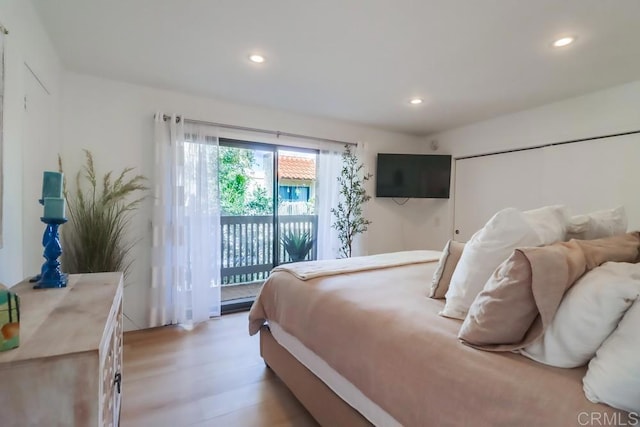 bedroom featuring light wood-type flooring and access to outside