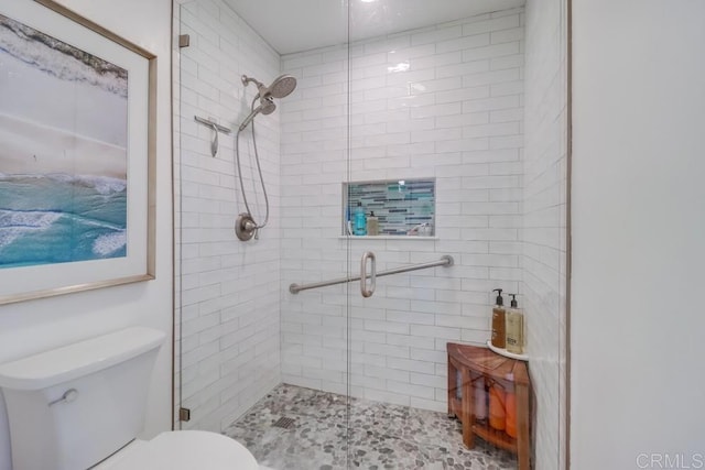 bathroom with toilet and an enclosed shower