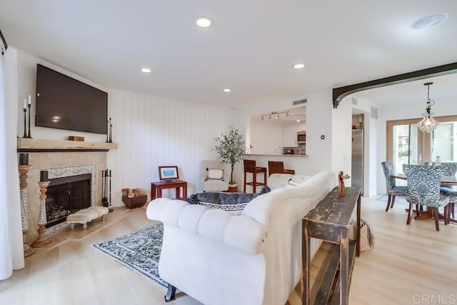 living room featuring wood walls and light hardwood / wood-style floors