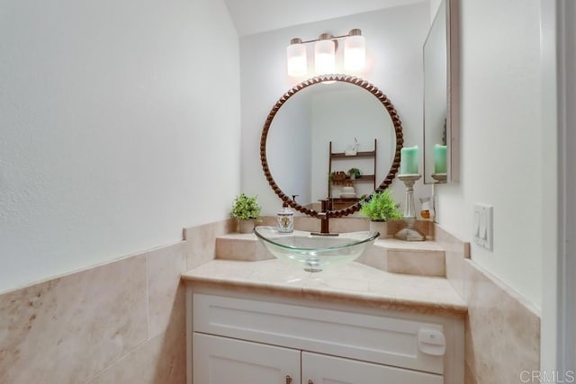 bathroom featuring vanity and tile walls