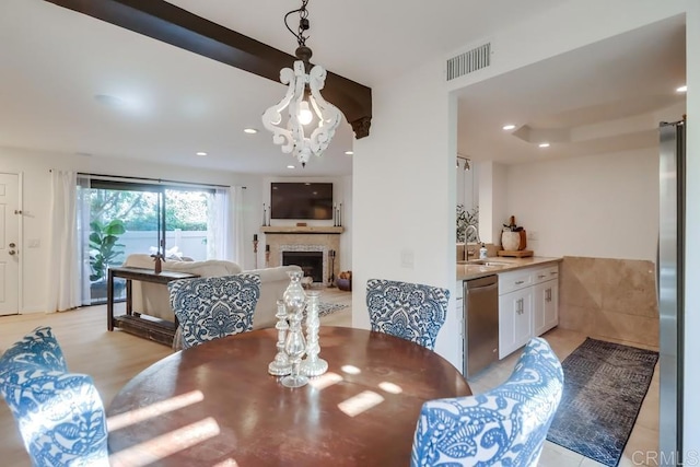 dining space featuring a notable chandelier and sink