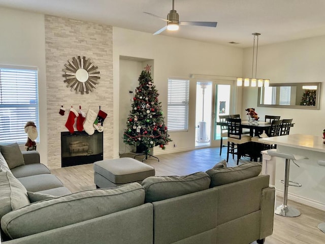 living room with ceiling fan, a healthy amount of sunlight, and light hardwood / wood-style floors