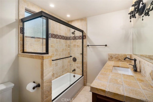 full bathroom featuring vanity, toilet, enclosed tub / shower combo, and tile patterned flooring