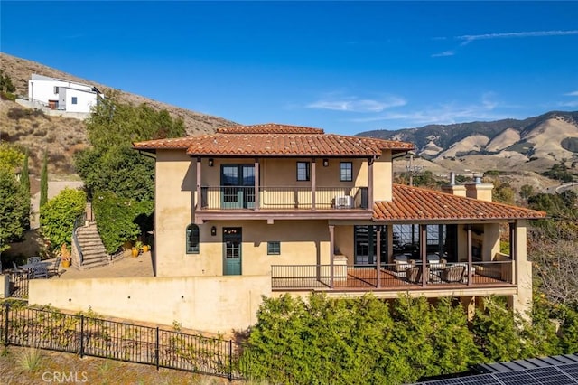 back of house with a balcony and a mountain view