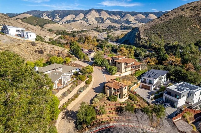 birds eye view of property with a mountain view